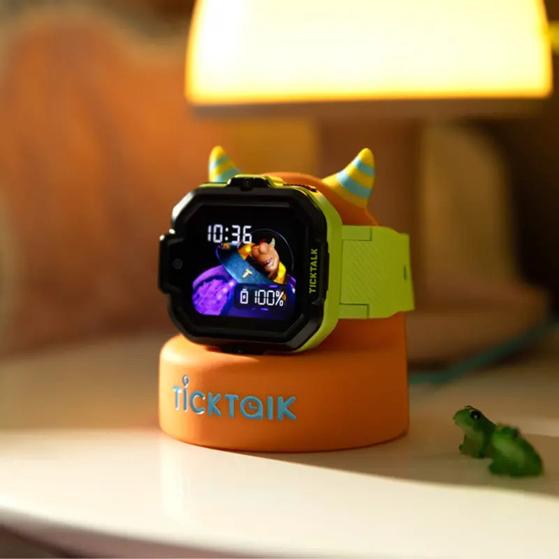 TickTalk kids smartwatch with a lime-green case on an orange charging stand